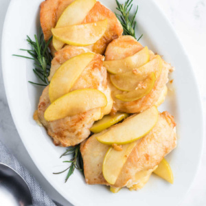 gouda stuffed chicken with apples on a white platter