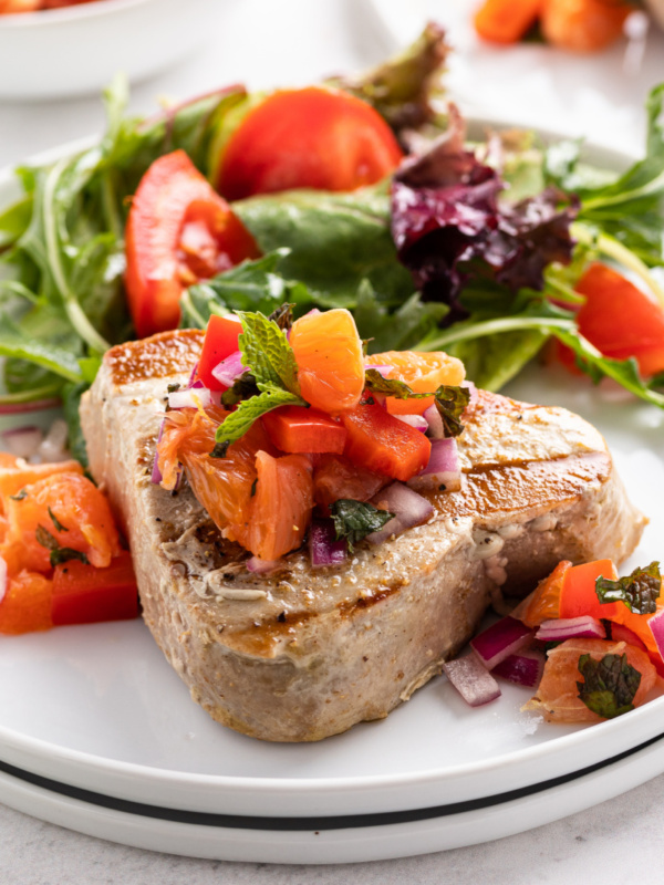 grilled tuna with citrus salsa on a plate with salad