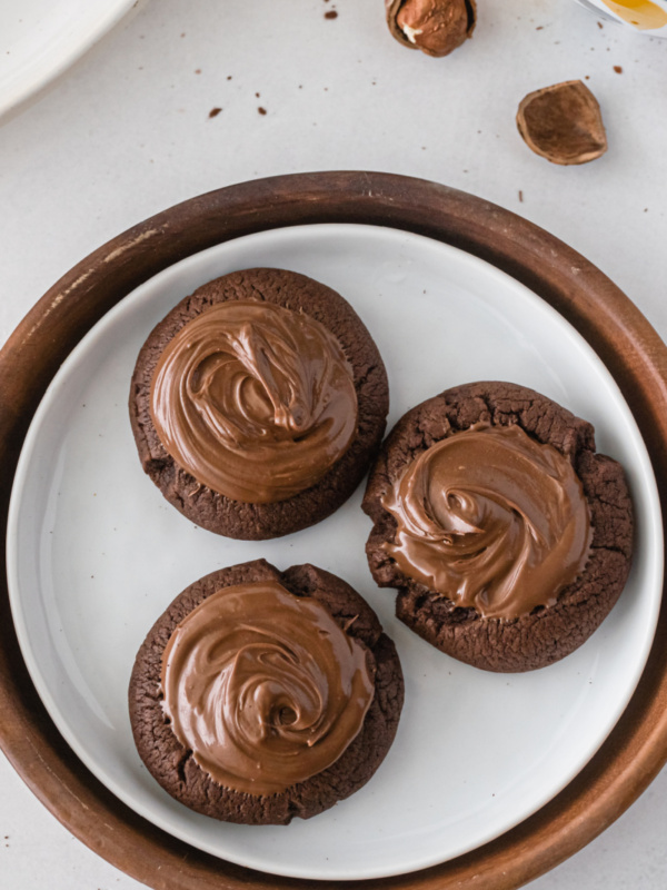 three nutella thumbprint cookies on a plate