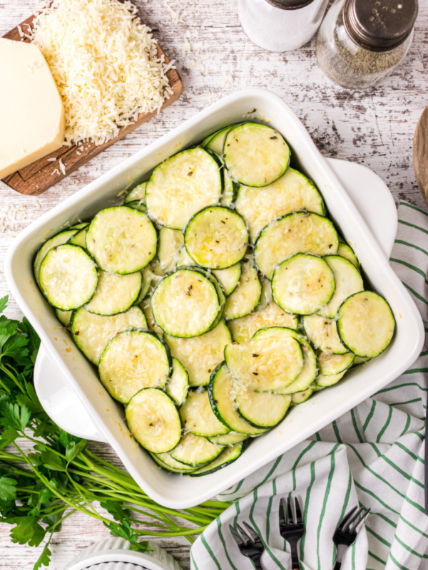 square white baking dish with parmesan zucchini slices