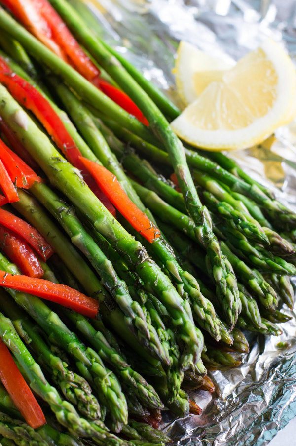 Red Pepper Confetti Asparagus in foil with lemon wedges