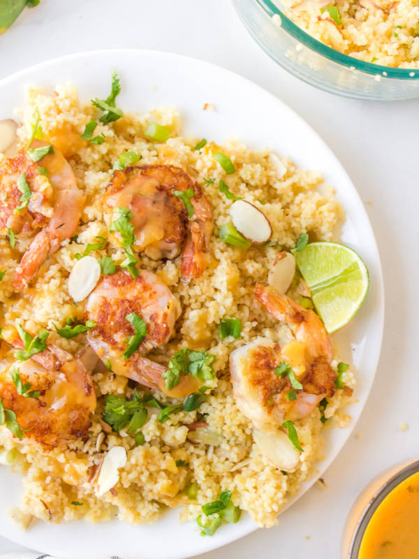 plate of shrimp with couscous and ginger orange sauce