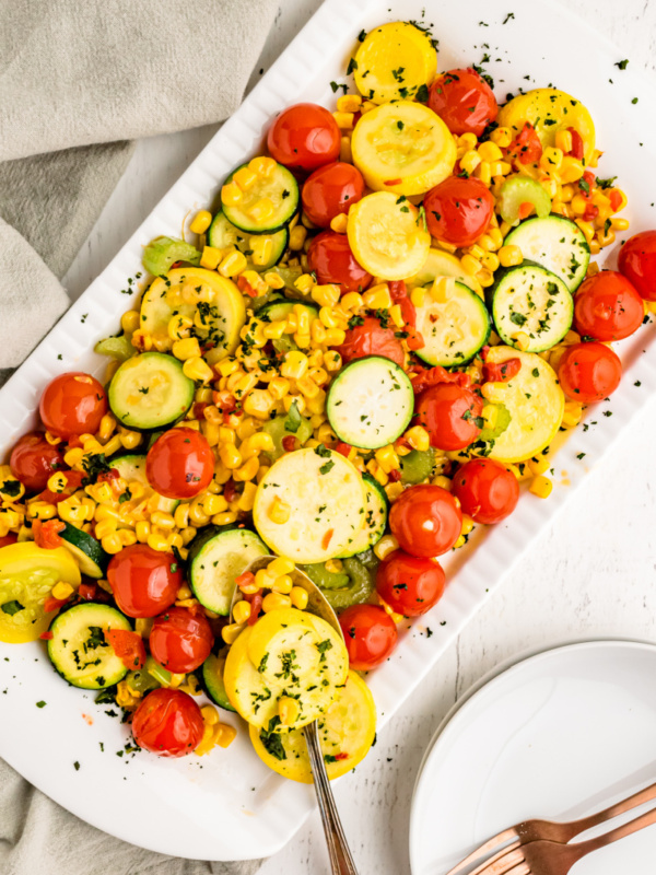 summer squash with cherry tomatoes on a platter