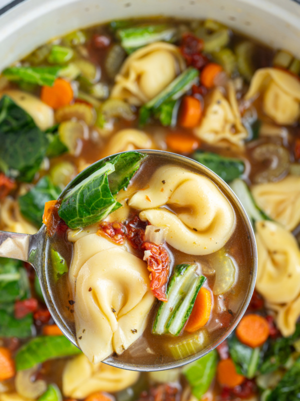 ladle full of sundried tomato tortellini soup