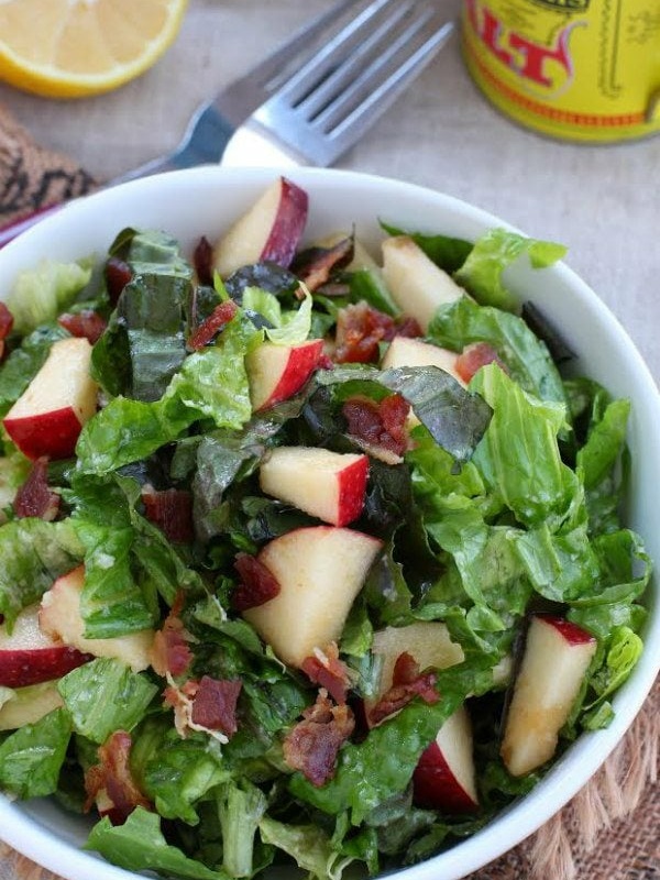 apple bacon salad in a white bowl