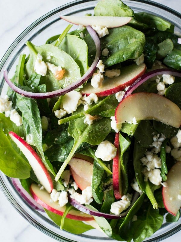 autumn apple and spinach salad in a bowl