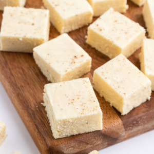 several pieces of eggnog fudge on a board