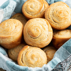 flaky dinner rolls in a basket