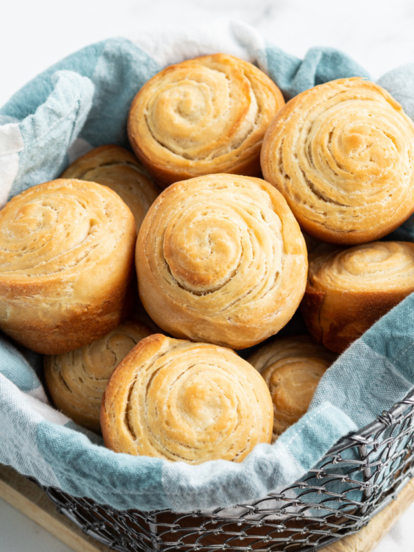 flaky dinner rolls in a basket