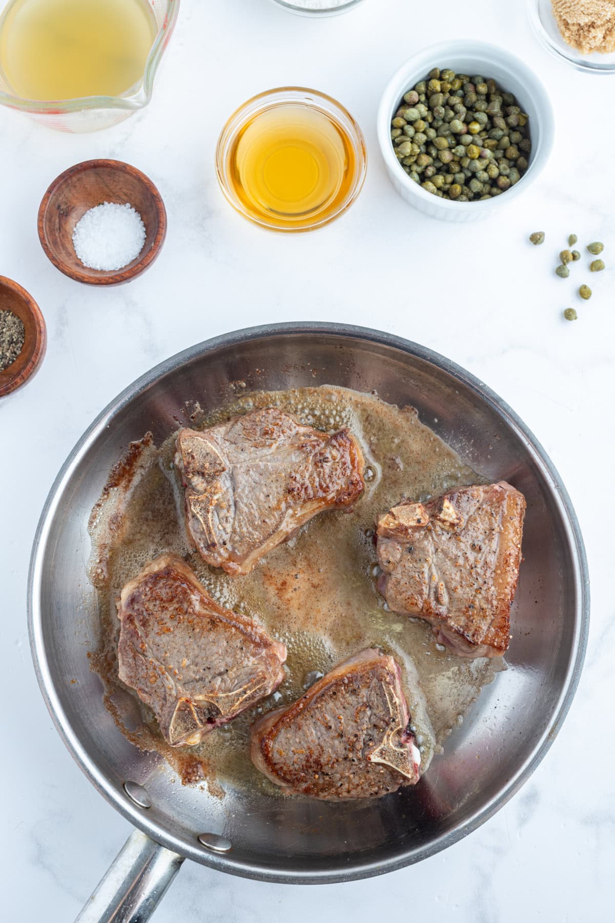 four lamb chops seared in pan