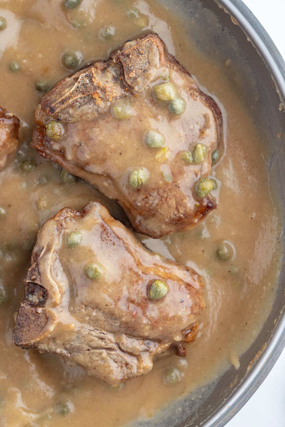 lamb chops in caper sauce in pan