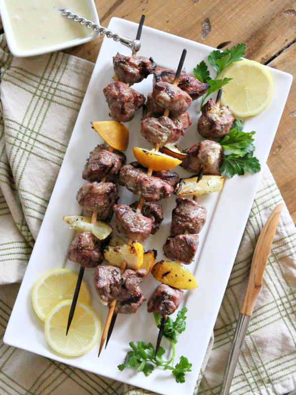 lemon garlic lamb kebabs on a white plate