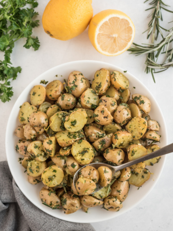 potatoes in bowl tossed with herbs