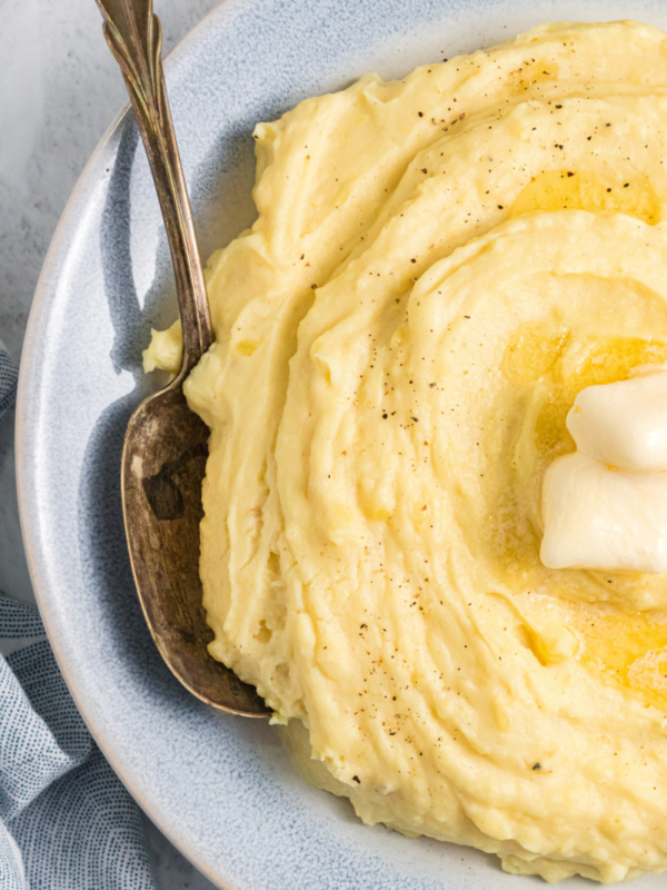 mashed potatoes in bowl with butter and spoon