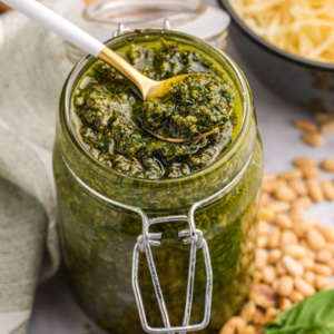 spoon in pesto sauce in jar