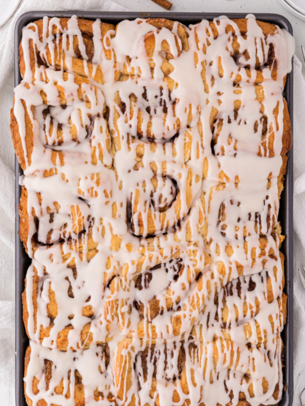 pan of cinnamon rolls with icing on top