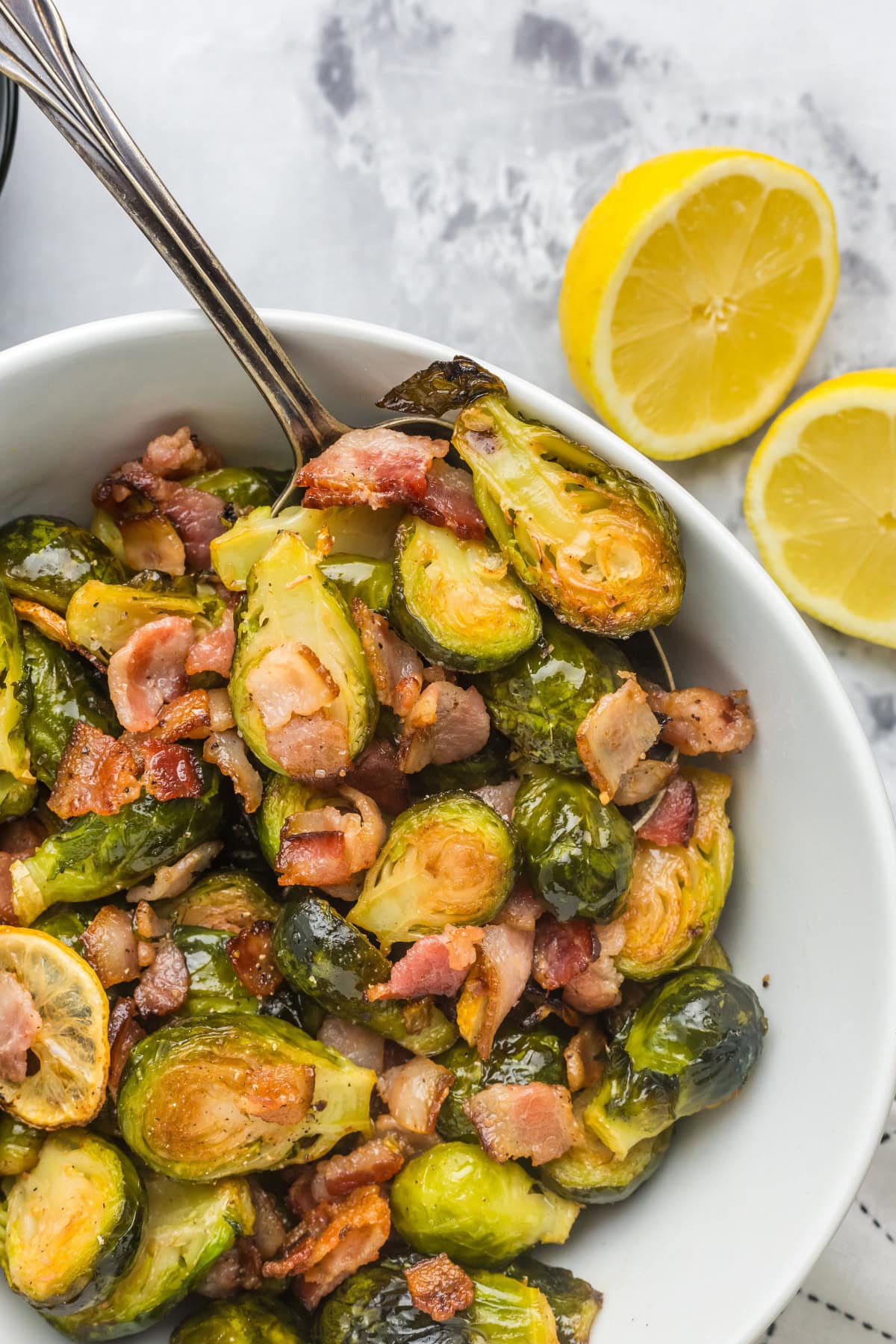 bowl of roasted brussels sprouts with lemon and bacon