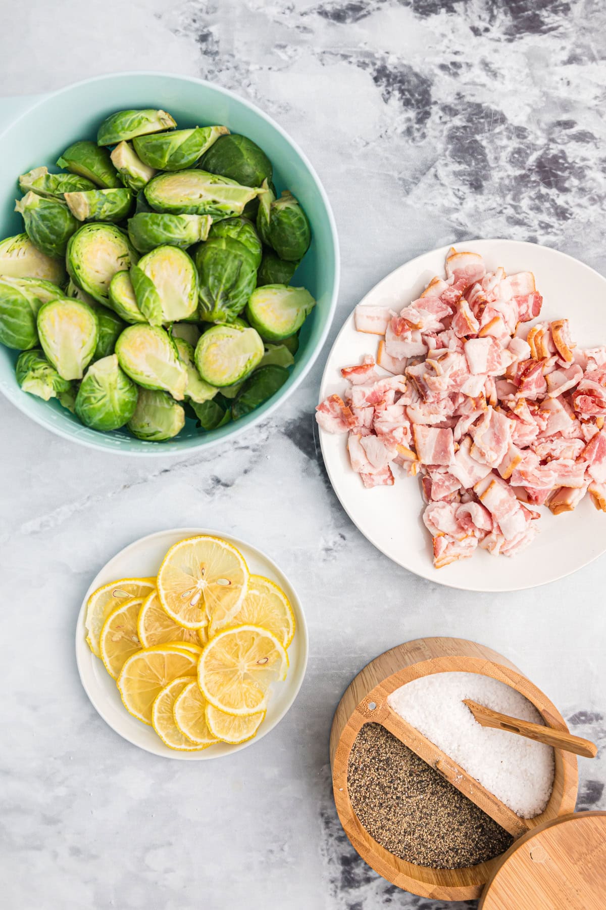 ingredients displayed for making roasted brussels sprouts with lemon and bacon