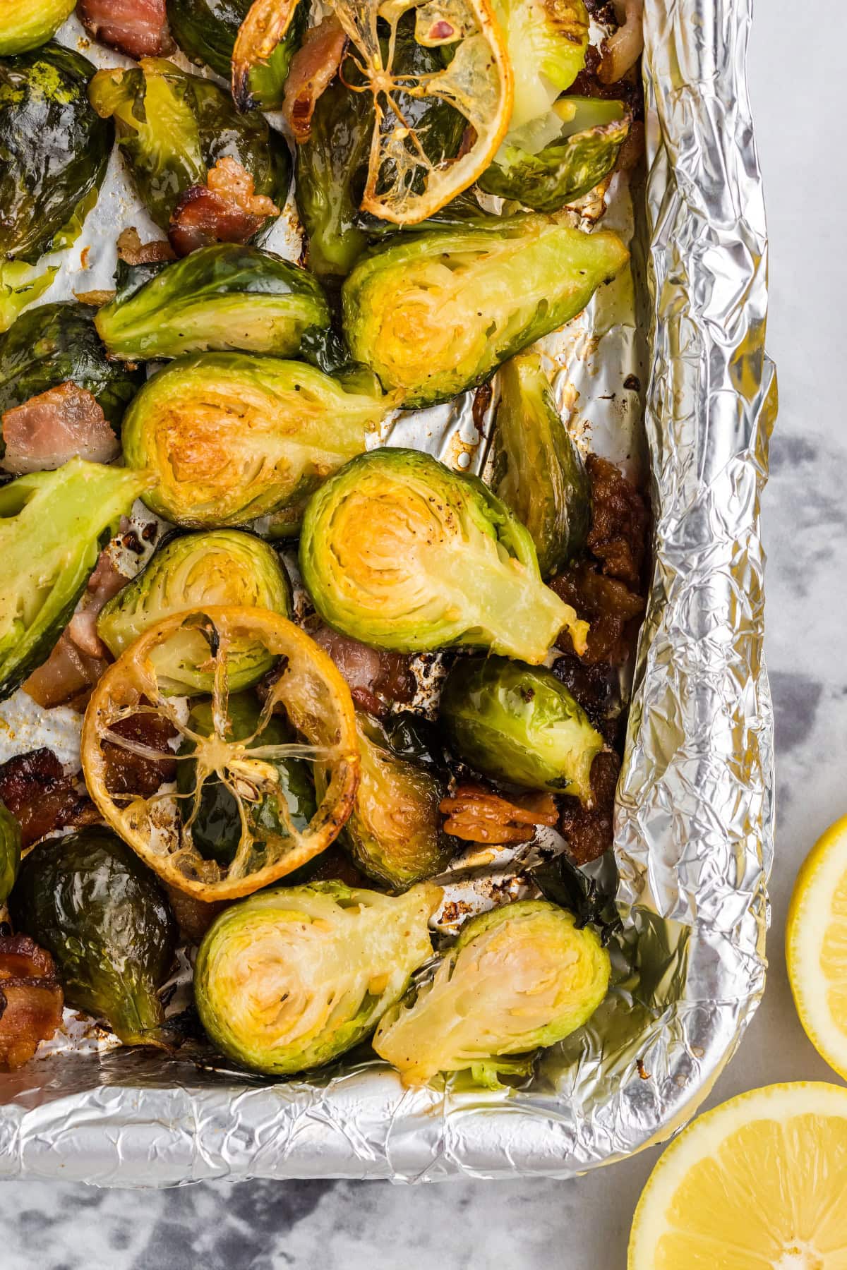 pan of roasted brussels sprouts with lemon and bacon