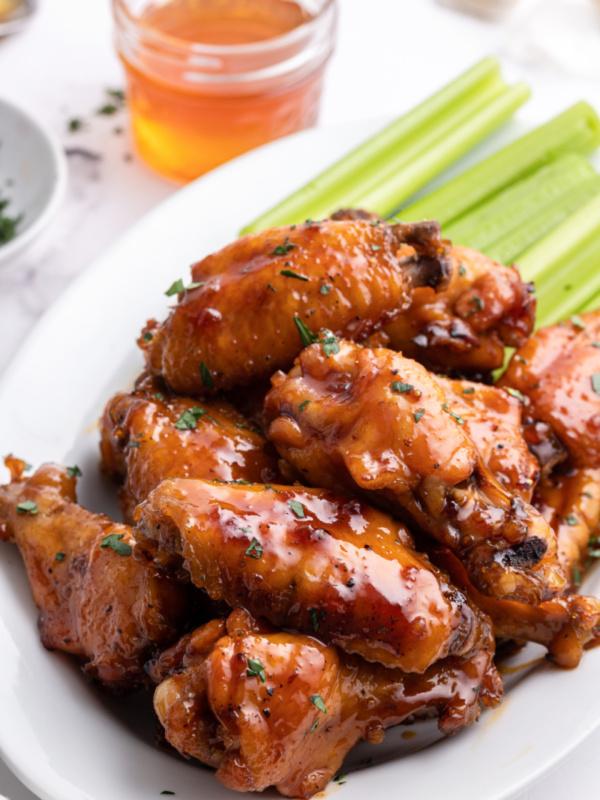 honey glazed chicken wings on platter with celery