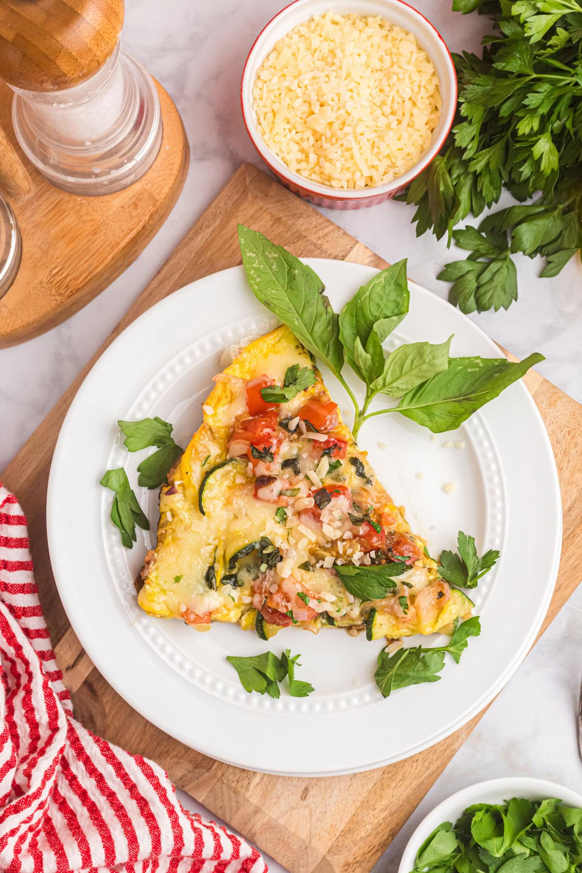 slice of squash and tomato oven frittata on plate