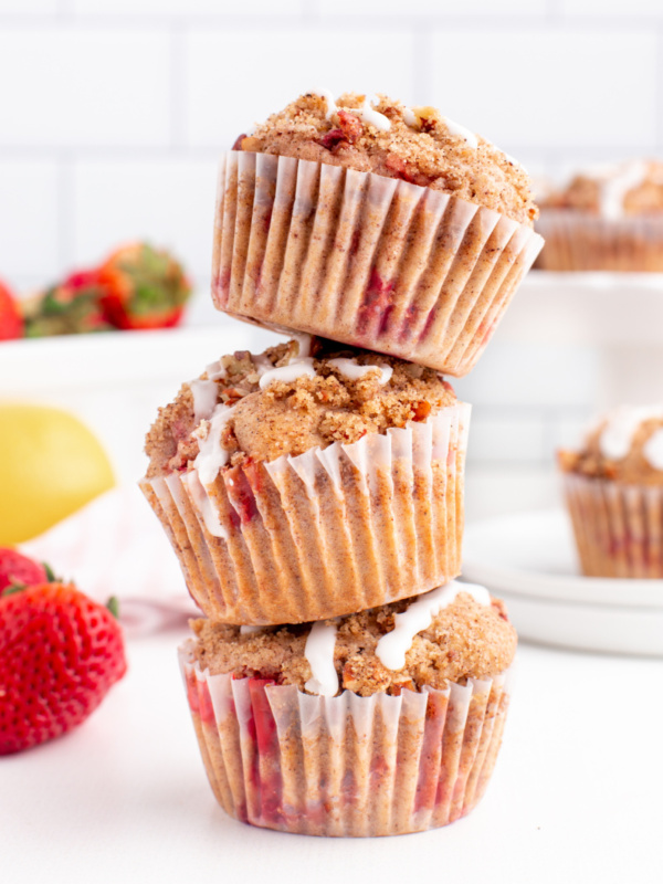 three glazed strawberry lemon streusel muffins stacked