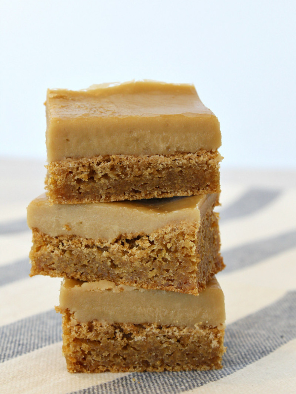 stack of 3 butterscotch brownies sitting on a blue and white striped cloth towel