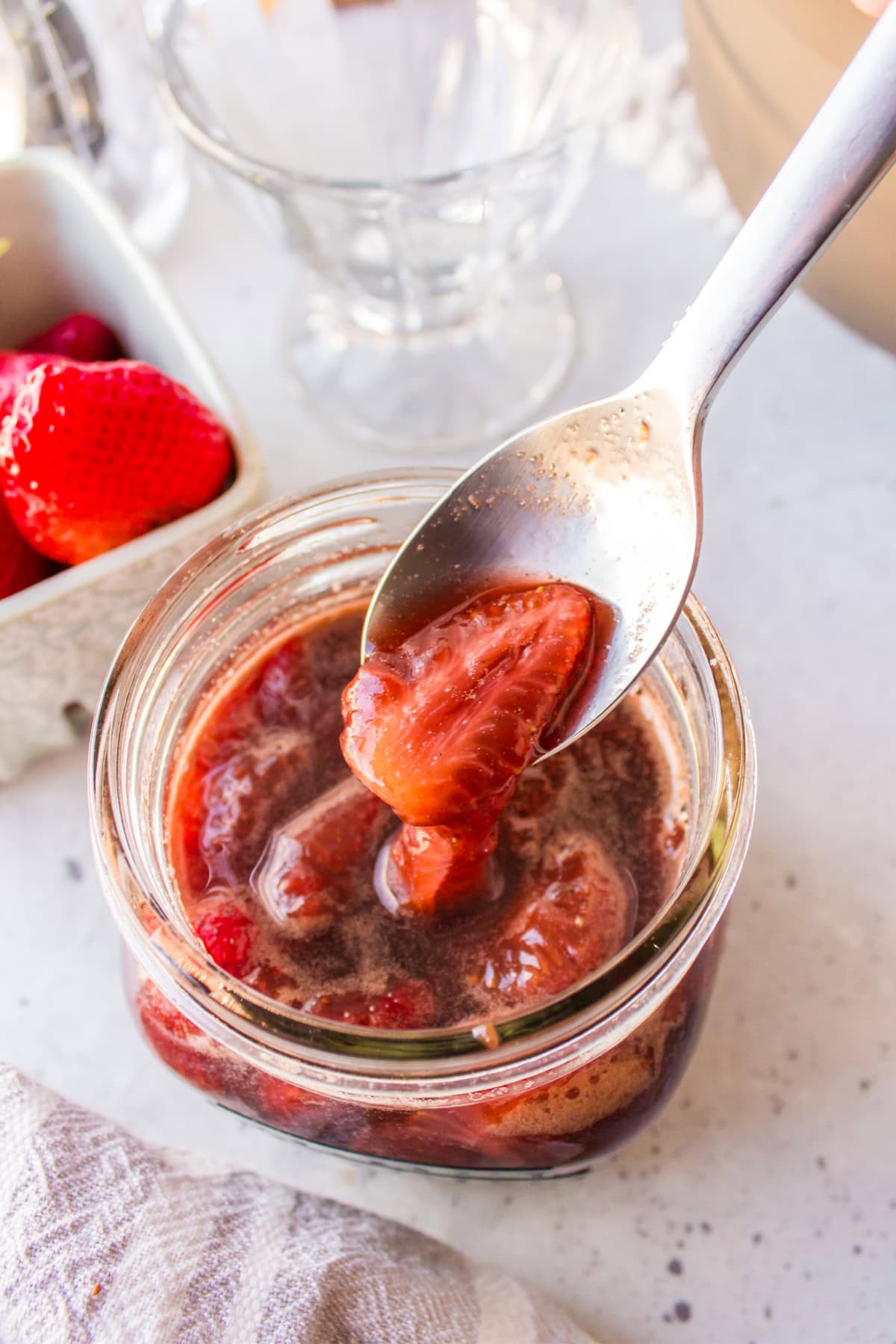spooning balsamic strawberry sauce out of jar