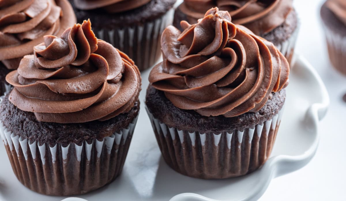 easy chocolate frosting on two cupcakes