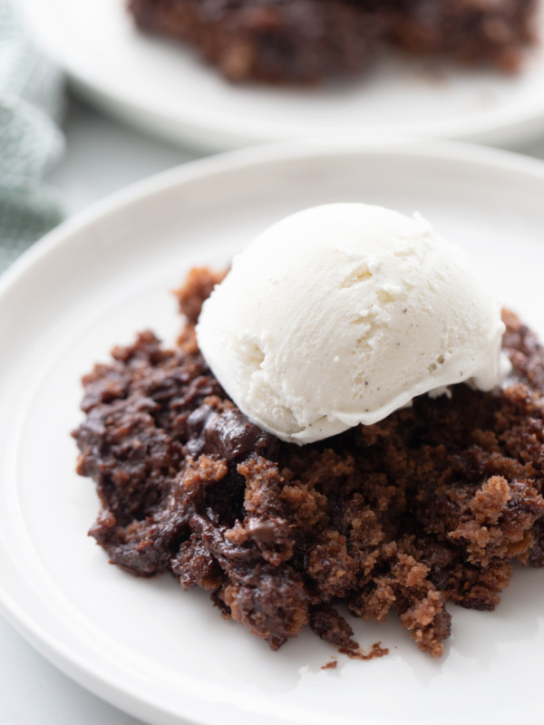 chocolate pudding cake topped with vanilla ice cream