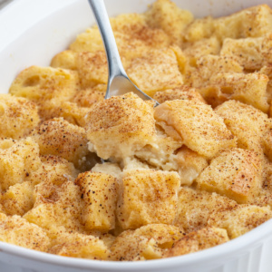 custard bread pudding in a baking dish with spoon