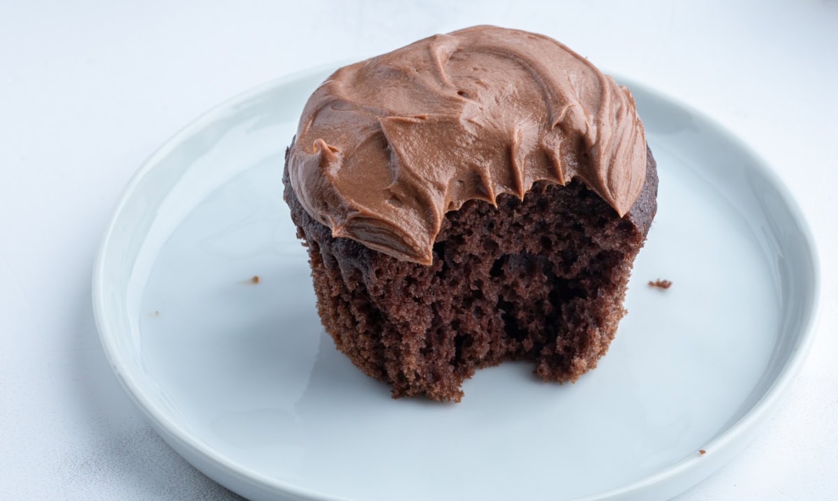 chocolate cupcake with chocolate frosting with bite taken out