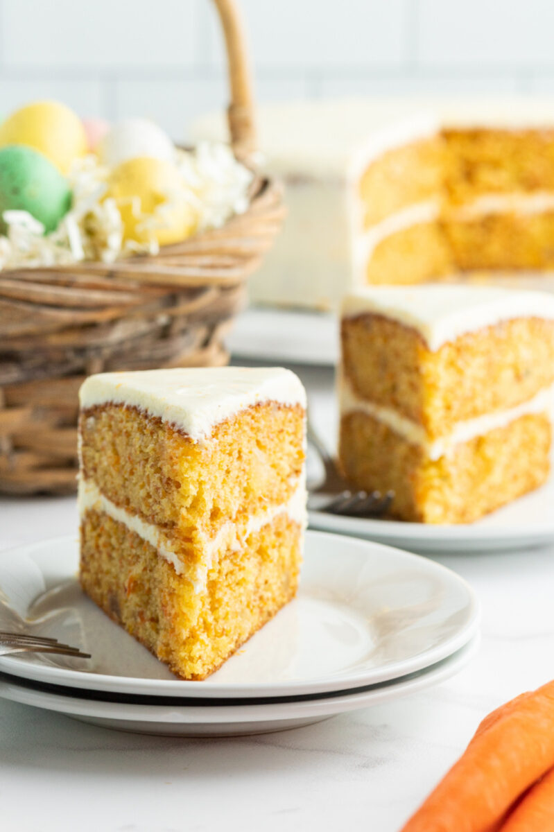 slices of carrot cake on plates with easter basket in background