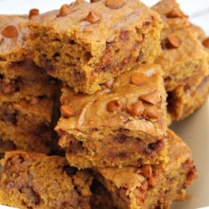 cinnamon pumpkin bars stacked on a white plate