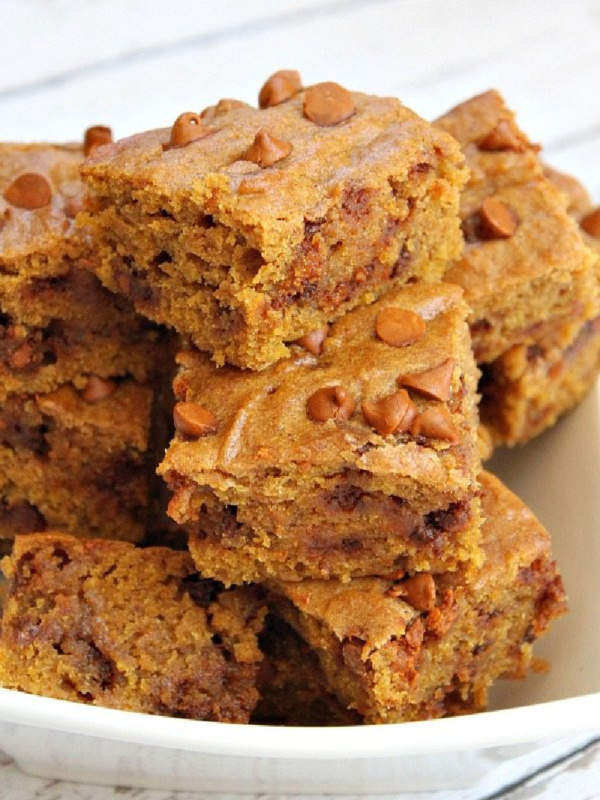 cinnamon pumpkin bars stacked on a white plate