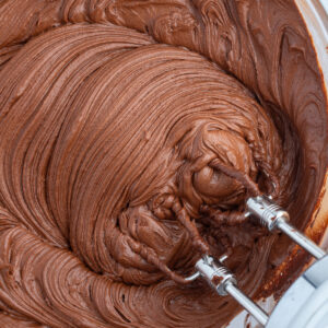 hershey's chocolate frosting in bowl with beaters