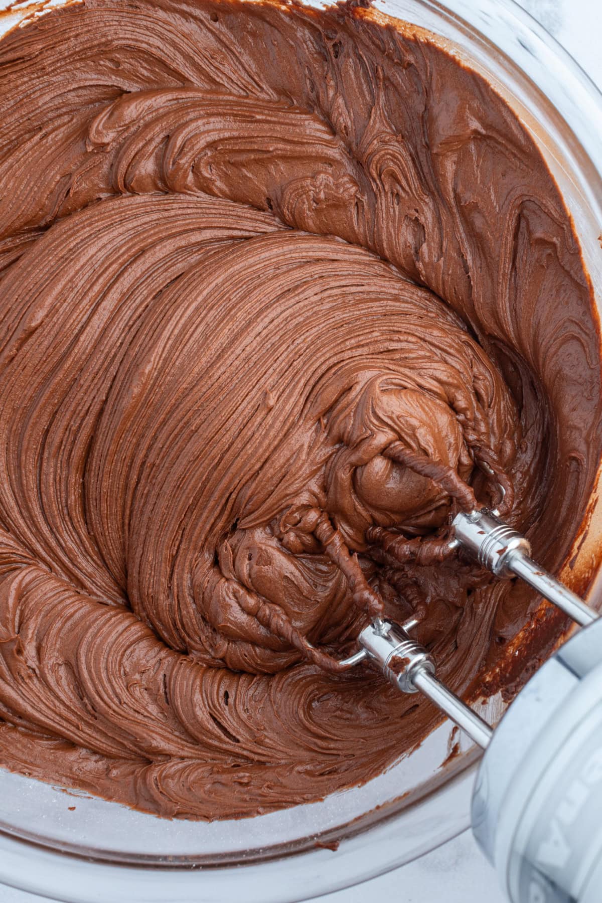 hershey's chocolate frosting in bowl with beaters