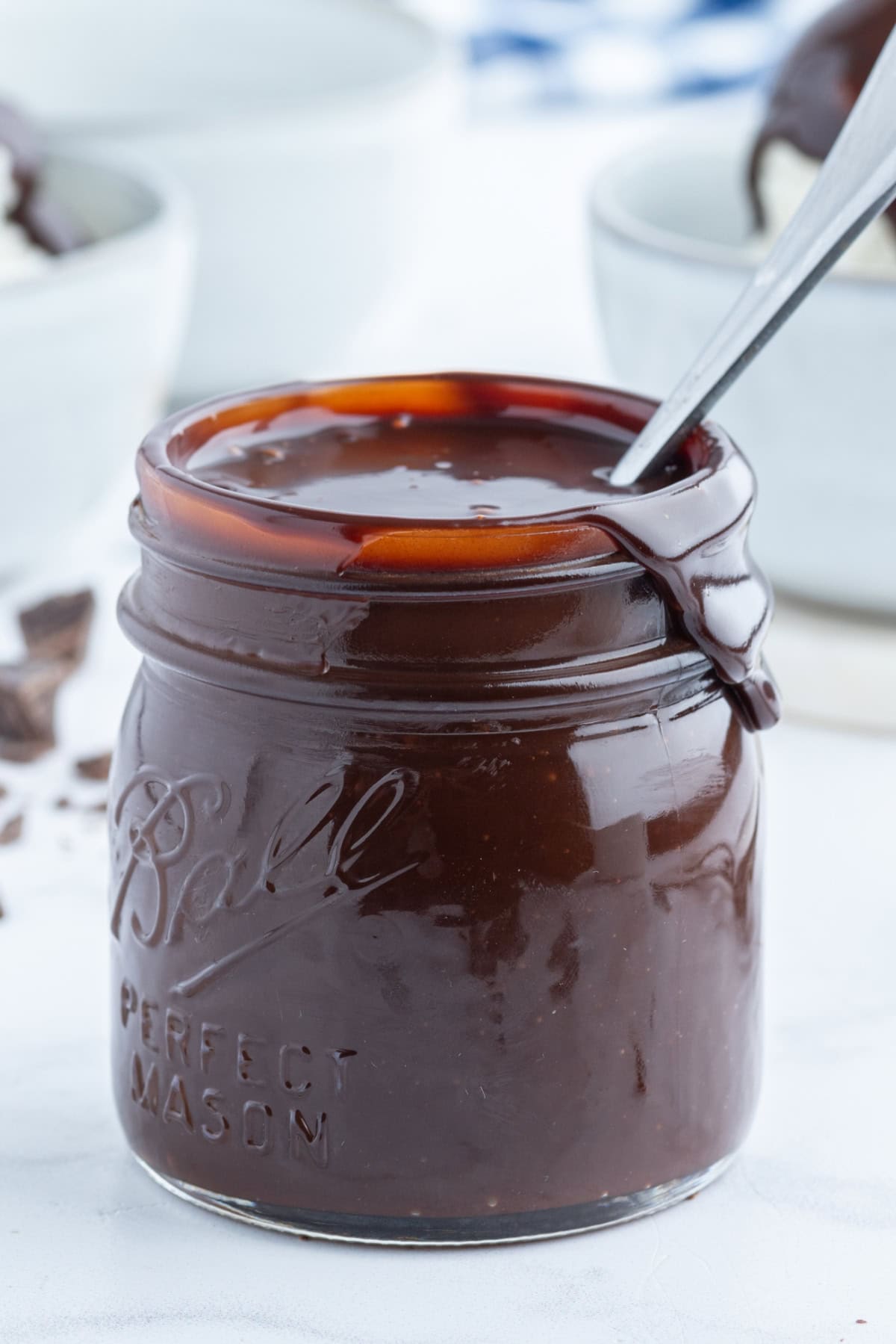 spoon in jar of hot fudge