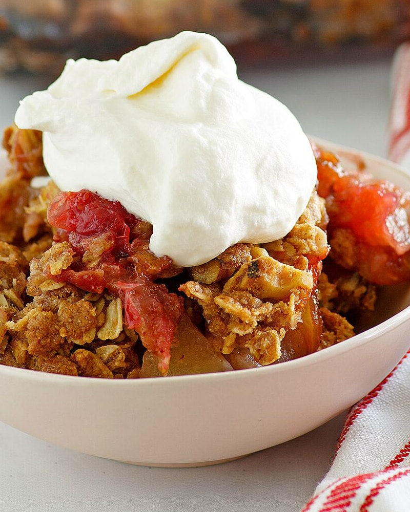 Bowl of Apple Cranberry Crisp with Maple Whipped Cream