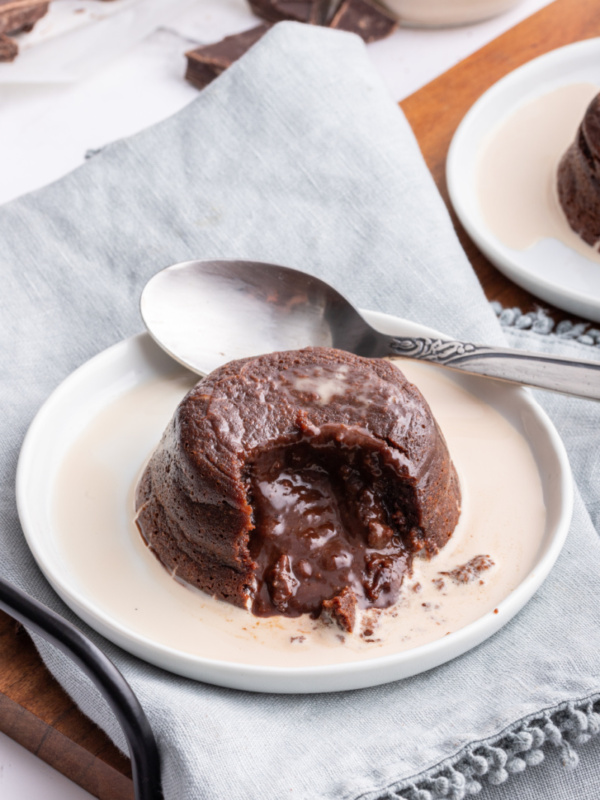 molten chocolate cake on plate cut open with chocolate inside coming out