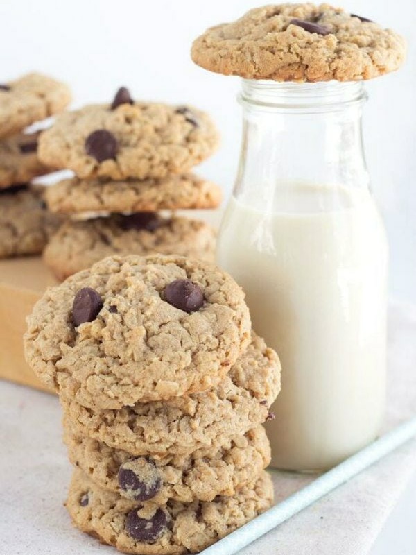 peanut butter oatmeal chocolate chunk cookies in a stack with a glass of milk