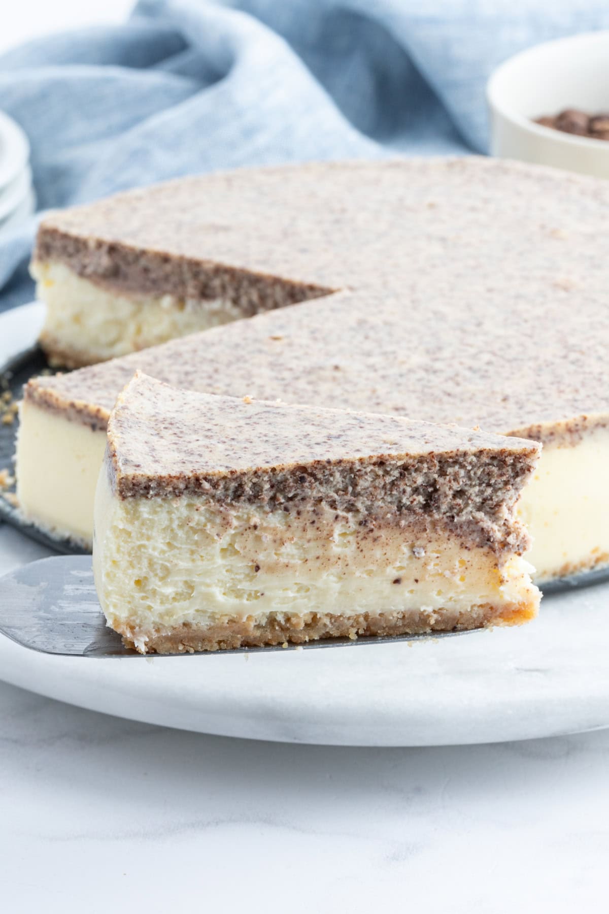 spatula taking out slice of tiramisu cheesecake