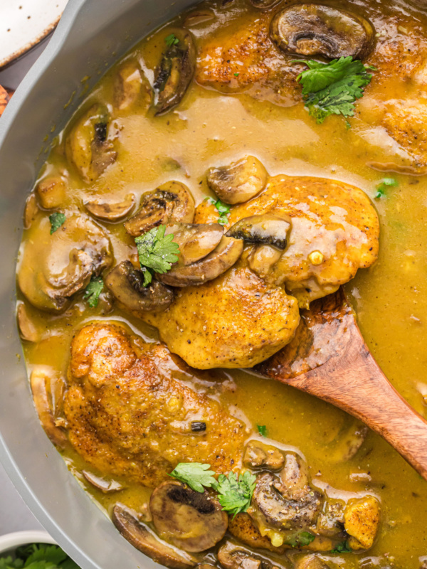 pan of amaretto chicken with spoon