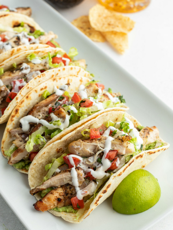 beer marinated chicken tacos on white platter