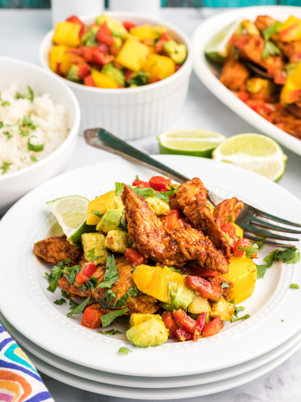 chili rubbed chicken with mango salsa on plate