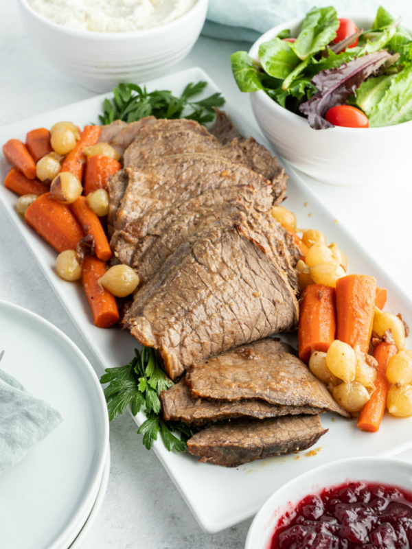 cranberry roast beef on a platter with vegetables