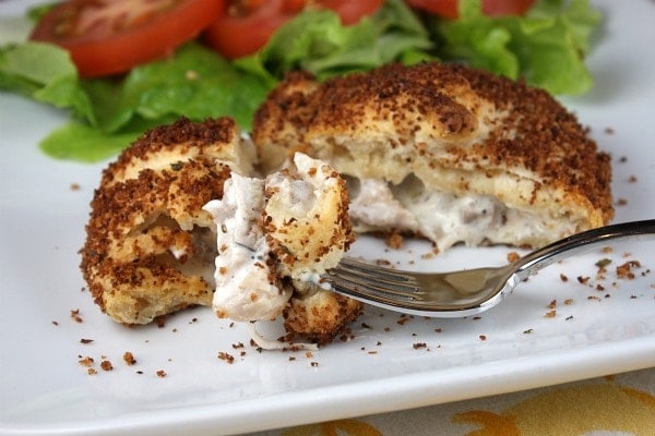 Croissant Chicken cut open with fork on white plate