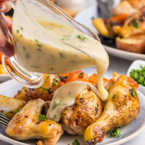 pouring gravy onto chicken