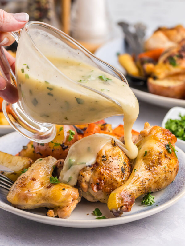 pouring gravy onto chicken