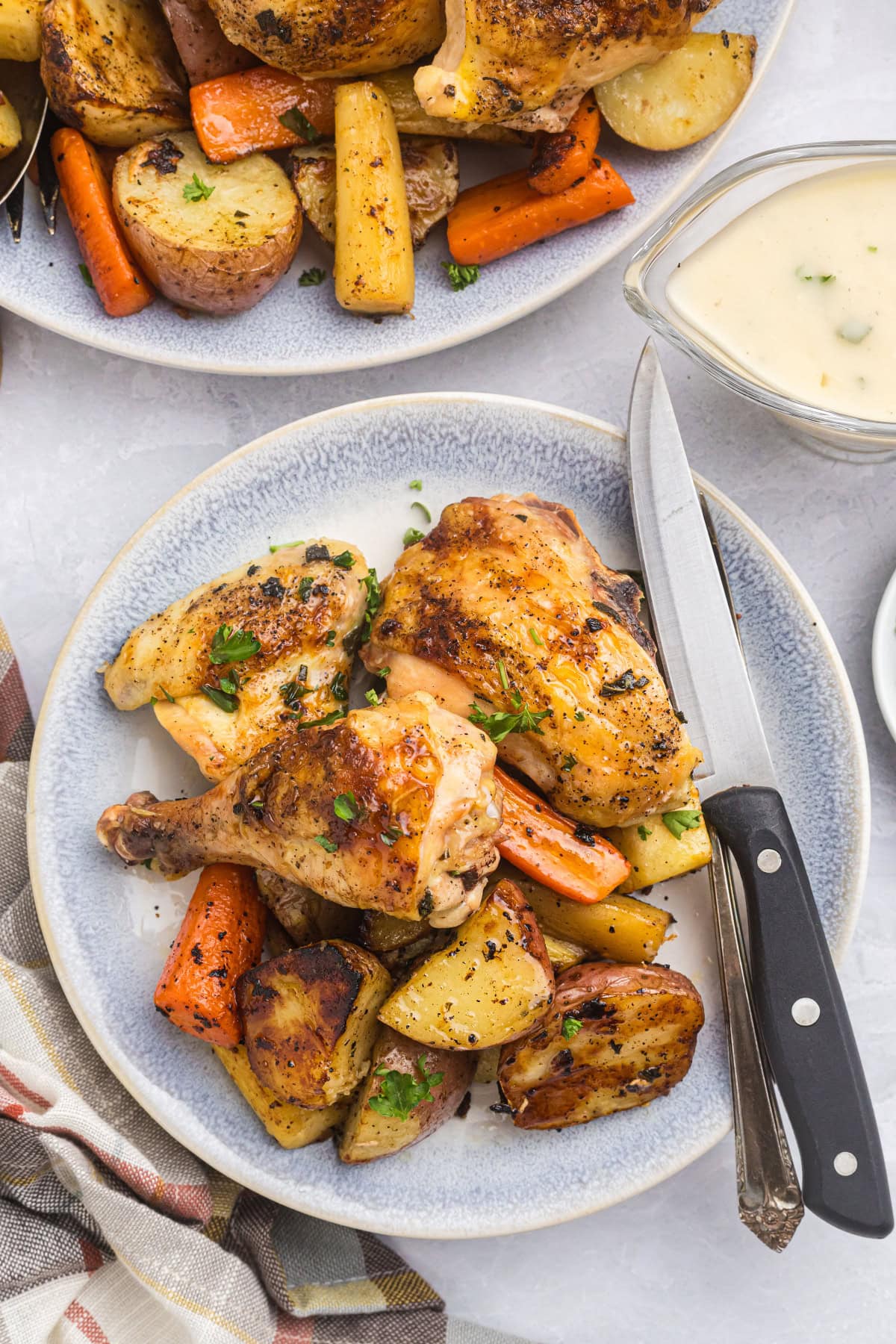 knife on plate of roast chicken